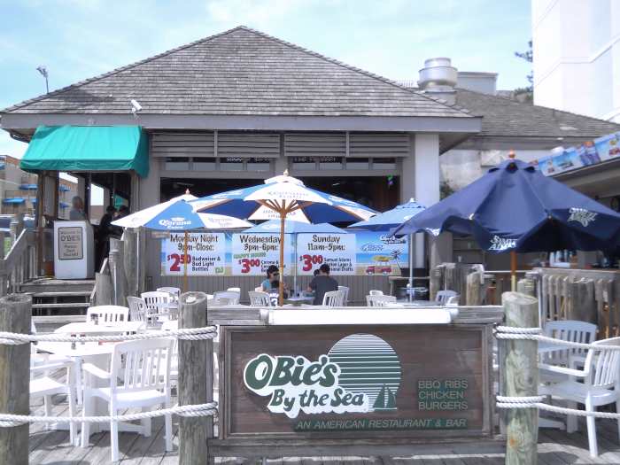 Outdoor seating has colorful umbrellas for shade. Indoor seating overlooks the ocean and the upper half of the walls are open providing an "outdoor" feel even though you're sheltered.