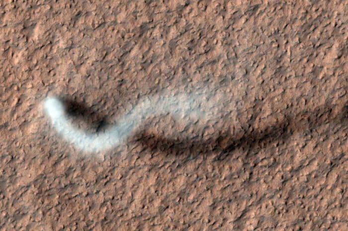 A dust devil casts a serpentine shadow over the Martian surface in this image acquired by the High Resolution Imaging Science Experiment camera on NASA's Mars Reconnaissance Orbiter.