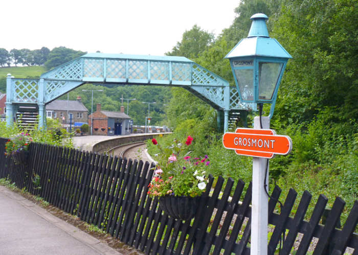 Grosmont, junction with Northern Rail branch to Whitby and North Yorkshire Moors Railway. Note detail touches, gas lamps with enamel name lozenge, footbridge, diagonally arranged platform fencing, brick open shelter on adjacent platform (distance)