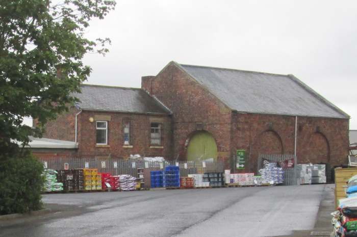 The goods shed and yard now stores building materials etc. The arch at this end was where wagons were shunted through or out. Access for carts, later lorries, was on the far side.
