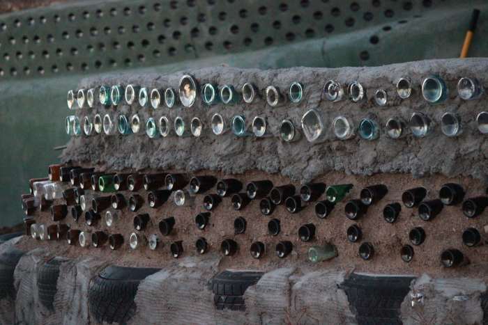 Earthship of Taos, New Mexico. Recycled bottles make up the bulk of this decorative fence.