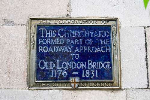 Early blue plaque marks the entrance through the churchyard of St Magnus the Martyr to the Old London Bridge of AD 1175-1831 when the predecessor to the modern London Bridge was built