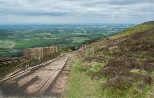 Looking down Ingleby Incline from Incline Top in 1928 (super-imposed on recent image). In the middle are four empty wagons that have been hauled up using the counterweight of four laden ones and one inch wire cable