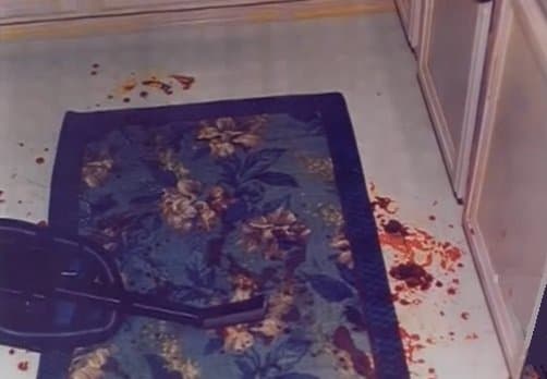 Rug in front of the sink. Blood drops on top of drops found here indicate that Darlie stood here bleeding for some time. It's believed this is where she stood and cut her throat and arm. The blood here was identified as hers