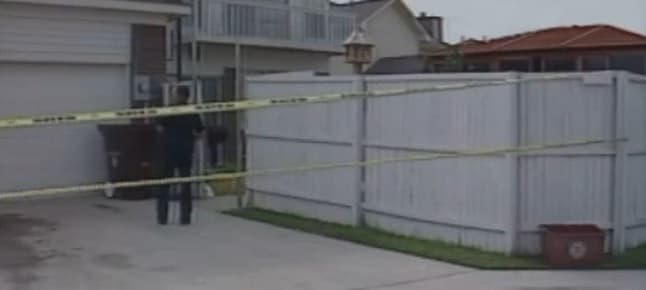 The faulty gate in the back yard. It was in place and secured when police officers checked the backyard