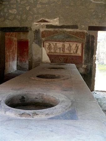 A thermopolium was the equivalent of a modern day cafe/bar. Hot and cold food was sold from what was usually an 'L' shaped masonry counter containing terracotta vessels. ©Jackie and Bob Dunn