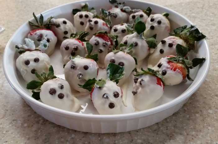 A neighbor made these fun ghost or skeleton faces. Wash, then dry strawberries. Dip them in white chocolate. Use mini-chocolate chips or chocolate icing to make the face.