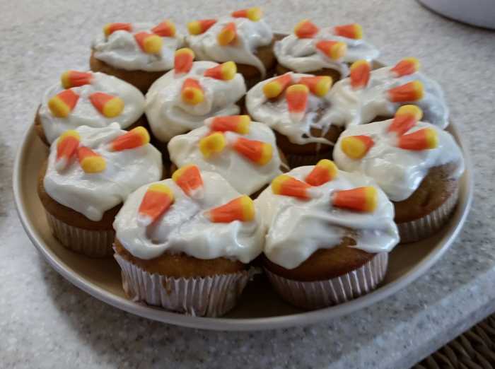 It doesn't get much easier than this. The cupcakes can be any flavor but I suggest pumpkin or a spice cake. Any icing is fine. I like a cream cheese. Then top it with some candy corns.