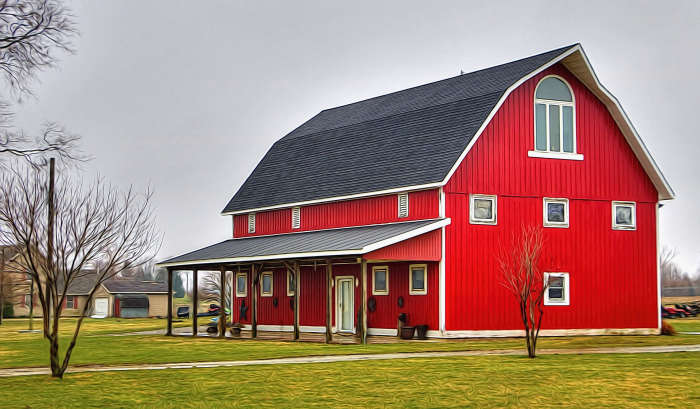 A lean to is attached to one side of a stable building. This barn is displaying this style of construction which is suitable for many uses. The remaining three sides may be covered or left open.