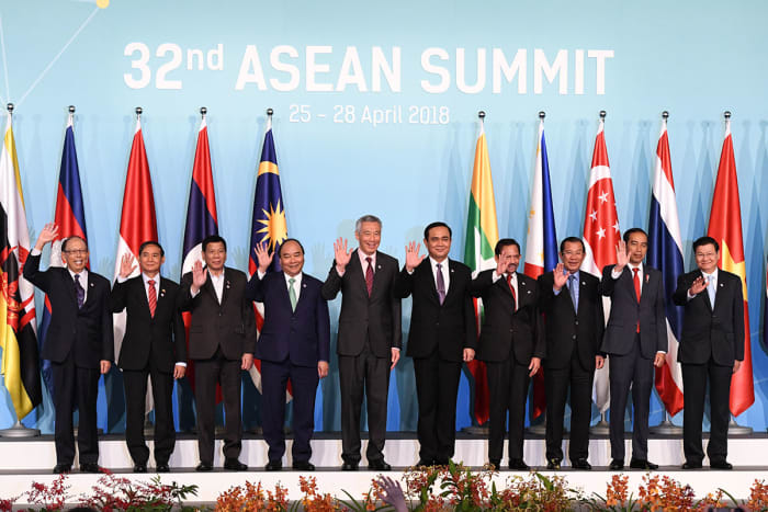 Leaders from 10 ASEAN countries wave during a group photograph at the opening of the 32nd ASEAN Summit
