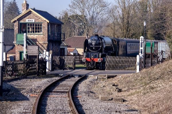 'Tornado' passes the level crossing at Bedale on her way with a train back to Leeming Bar