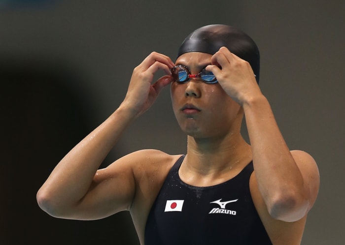 Natsumi Hoshi adjusts her goggles prior to the second heat of the 200 meter Women's Butterfly swimming competition in the 2012 Summer Olympics in London, England.