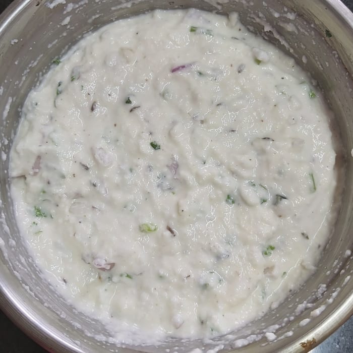 Mix everything properly to form smooth batter. Don't add water. Cover and keep aside for 15-20 minutes or until rava is soaked well.