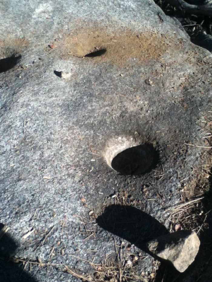 Shadows inside the holes of the metate rocks. The metatee rocks is where Serrano Indians used to grind acorns into meal to make flat breads and mushes.