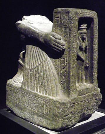 Statue of the priest Amenmose, 11th cent. B.C. He kneels and holds the chapel with Goddess Hathor (Turin, Egyptian Museum)