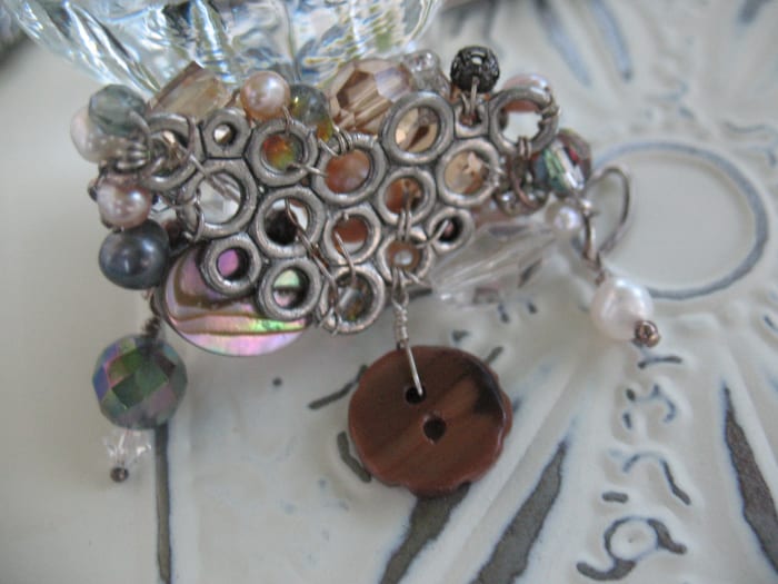 Here you can see the back side of the brooch pictured above. I used 24 gauge wire to secure the beads in place and hold the pin backing on. The higher the number for a wire's gauge, the thinner the wire.