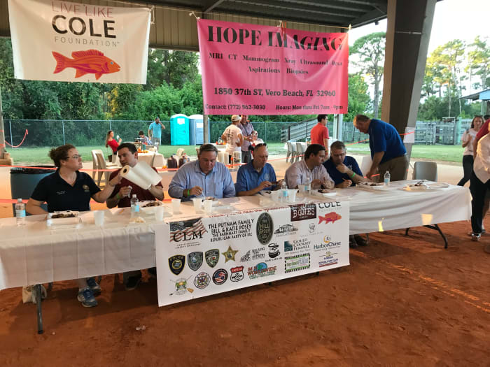 Seriously, that is him in almost 100 degree weather. He is the one sitting underneath the "Cole" sign and the red fish.