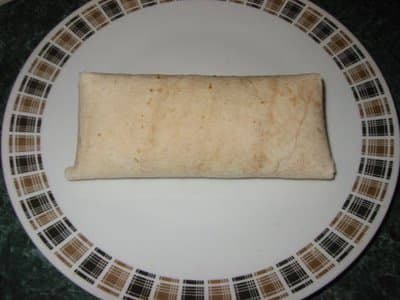 Fold your top flap down and turn your chimichanga over to hold the flaps in. Let them rest this way on a tray in the refrigerator 45 minutes before you deep fry them.