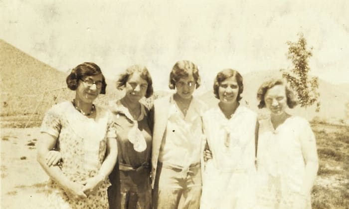 Bertha McGhee is the one in the dark dress with the sailor tie. I see a little plaid pattern in that dress. I'm not sure which names go to which teachers in this photo yet.