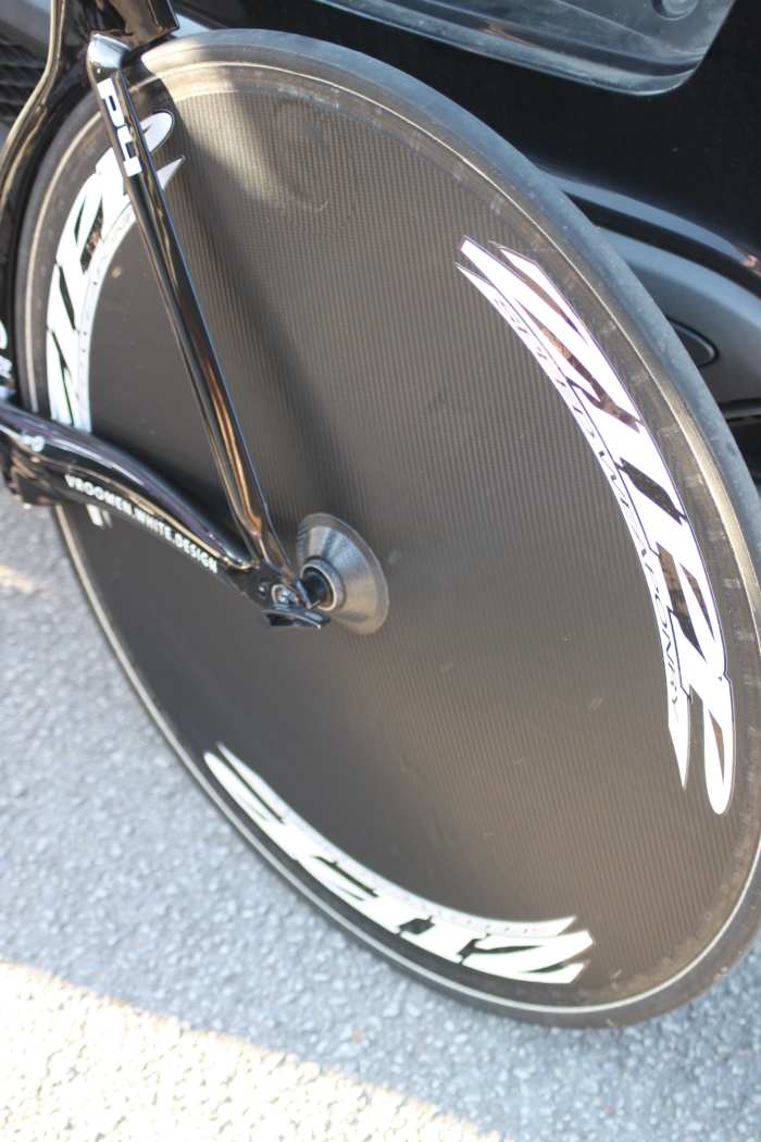A disc wheel doesn't use spokes. A layer of carbon provides the link for an aerodynamic advantage. Pictured is a carbon disc wheel marked as a Zipp disc. I'll offer a cash prize to anyone who can tell me what disc wheel this actually is.
