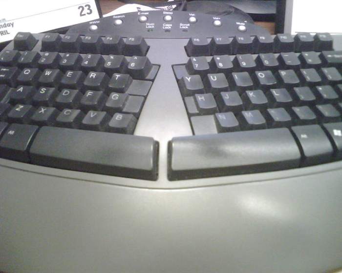 An ergonomic keyboard is designed to minimize muscle strain by creating a shape that is natural to the hands.