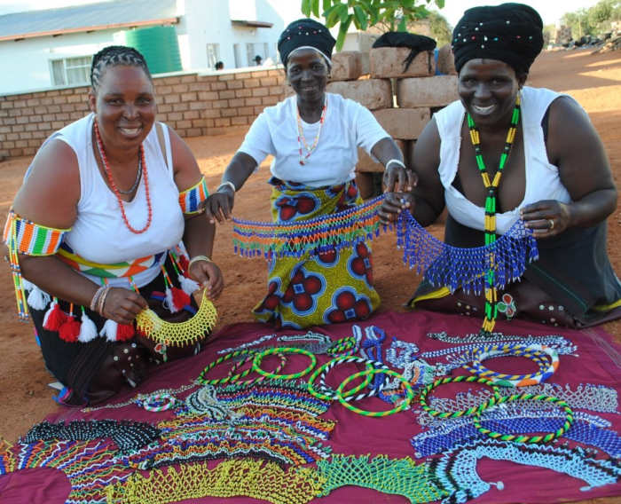 Bapedi women hawking their wares: Embroidered Beads. The Pedi are of Sotho origin. The name Sotho is derived from batho ba baso,meaning dark or black people. All available evidence indicates that the Sotho migrated southwards from the region of the G