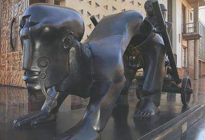 Feni Expressing The Burden that Africans Feel and being carried along with; He Carved this Stature artistically and spiritually expressing the sobering said reality that Africans themselves Are a best of Burn-Articstically/Sculpturally