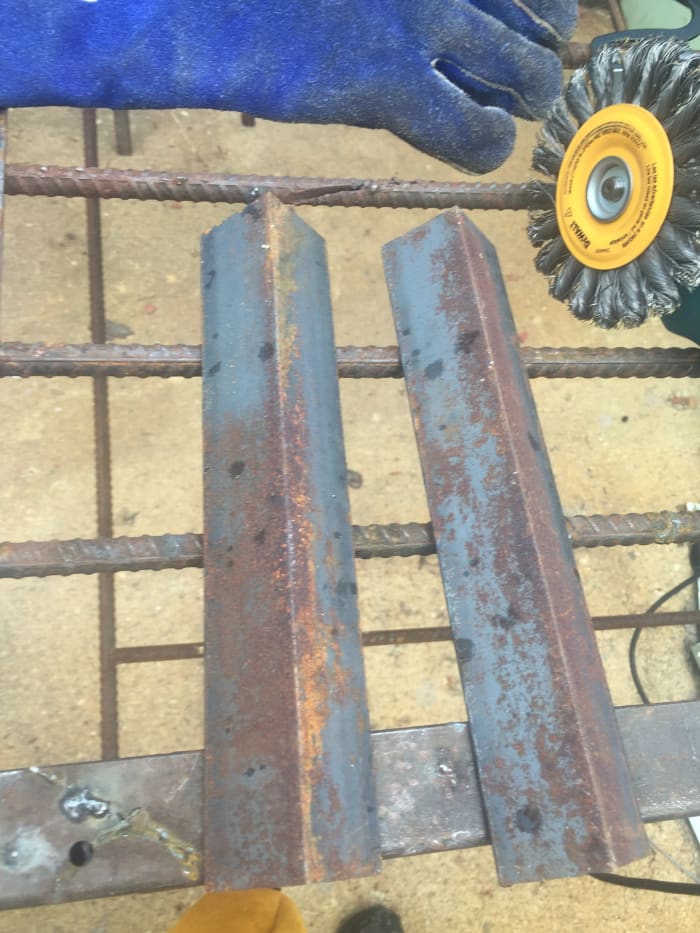 Left over angle iron scraps to be converted into support brackets for a wooden work table.