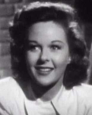 Susan Hayward's roundish face looks longer and squarer because of the squared, geometric style that draws the eye down the entire length of her face.