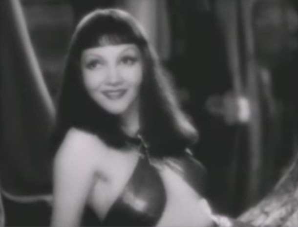 Claudette Colbert's face looks so nice and long with this long hair. The bangs cropped midway down her forehead give the impression of a long forehead. But hold on...