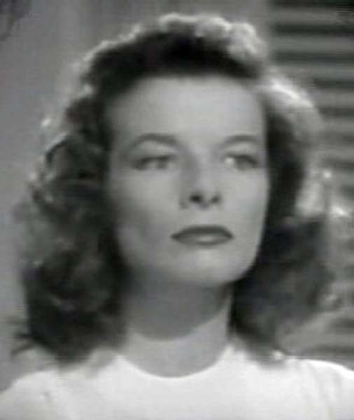 Katharine Hepburn's face still looks square in The Philadelphia Story, but without the bangs, it appears much less squashed. Her curls round out and soften the top of her head and the angles of her face, ending prettily below the neck.
