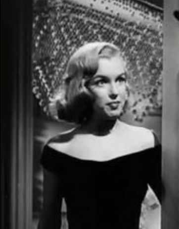 Guess who? Marilyn Monroe again, and not the most flattering look, as the length of her hair is almost exactly the length of her face and the style is too close to her face.