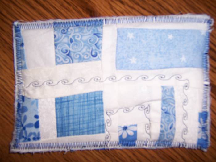 This postcard was made by sewing scraps of fabric together, and using different stitches on the sewing machine for decoration.