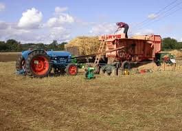 The farmers in the fifties or there about after collecting all their bundle of wheat, barley or oats etc. Used to thresh them with one of these threshing machine, driven ether from a tractor or a steam engine. It was hard work to collect the produce.