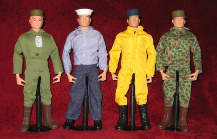 G.I. Joe as he looked straight out of the box in the 1960s. From left to right: Action Soldier, Sailor, Pilot and Marine. The soldier is wearing the dog tag that came with all G.I. Joe figures. The pilot flightsuit came in both yellow and orange.