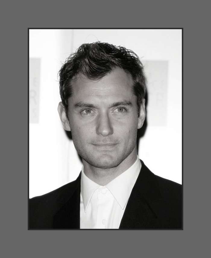 Jude Law's hair is cut in layers short on the side and longer in top and styled with a soft wave covering a little of the forehead - 2013 Hairstyles for Men with Balding Thinning Hair Style Cuts Trends