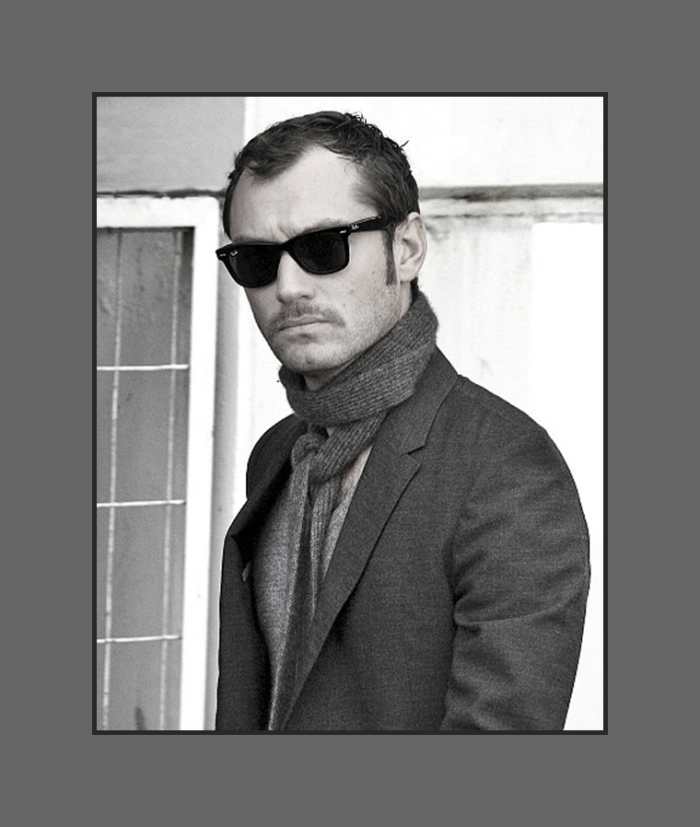 Jude Law's hair is cut short layered all over with long thin sideburns, styled flat giving a bold look - 2013 Hairstyles for Men with Balding Thinning Hair Style Cuts Trends