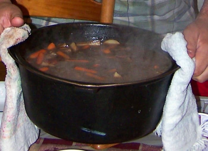 My favorite cauldron is my kitchen cauldron, which I use for (edible) kitchen witchery. Here my husband is carrying over our family's traditional Samhain beef stew brew to the table-- cooked with love & a touch of magic.