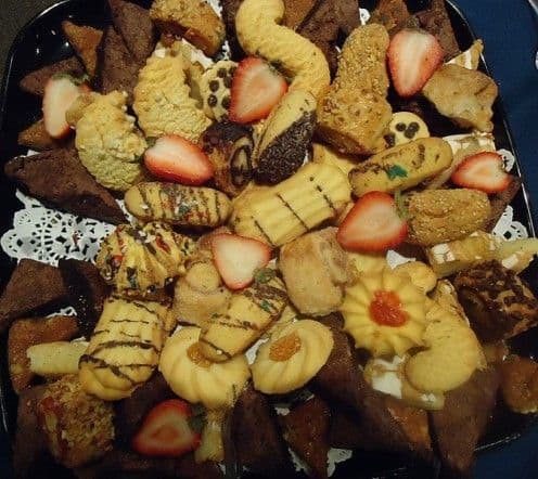 A variety of wedding cookies with strawberries. Adding fresh fruit is a great way to enhance your wedding cookie table.