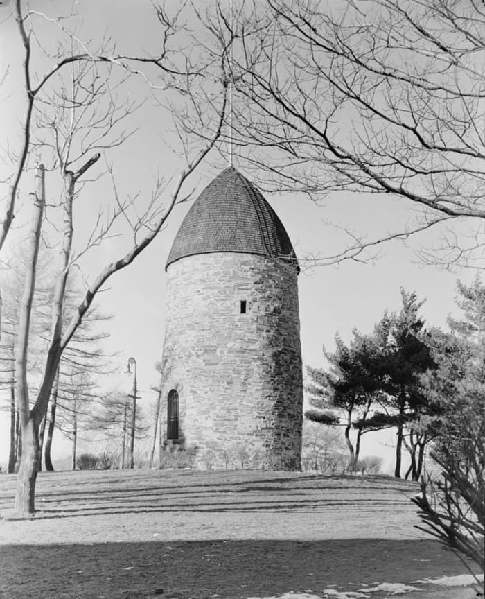The Old Powder House in Somerville, Massachusetts, as it stood in 1935, atop the hill at Nathan Tufts Park overlooking Powder House Square.