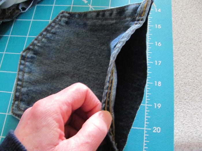 cut out back pockets of jeans, front and back, as close to seems as possible