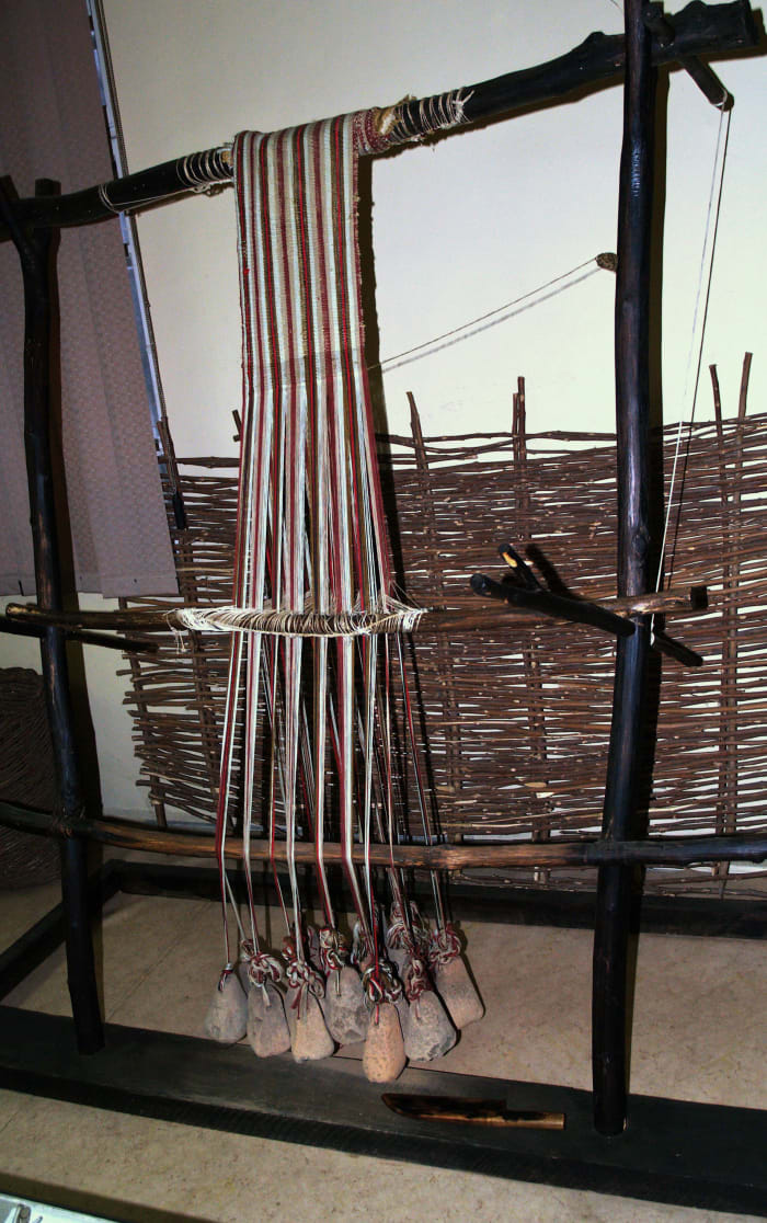 This reconstruction of a neolithic loom shows loom weights at the bottom of the apparatus. (At the National Museum of Textile Industry, Sliven, Bulgaria)