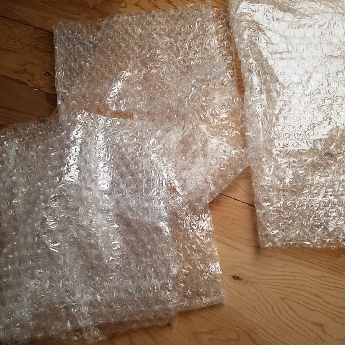 This bubble wrap came with my mother's paintings when she sent them to us. Our attic has space for us to have fun rolling around on it.