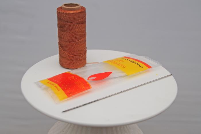 A doll needle, natural fiber pipe cleaners and thick sewing thread. I used leather sewing thread.