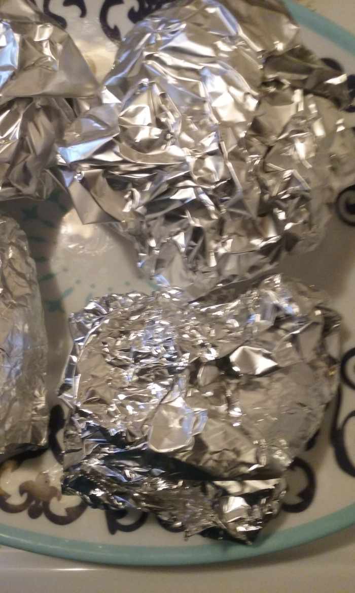 Wrapping the prepared burgers in foil helps to keep the juicy and delicious burgers from drying out.