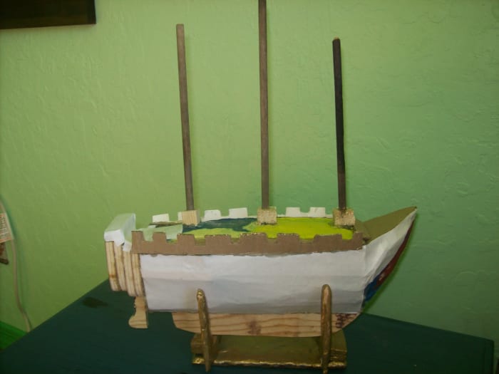 The model with all of the main features. The sails are yet to be built, but you can spray paint the model now, probably black or brown. Your sails will be painted white. Stand is made from bake clay, too. I use this stand for a model build.
