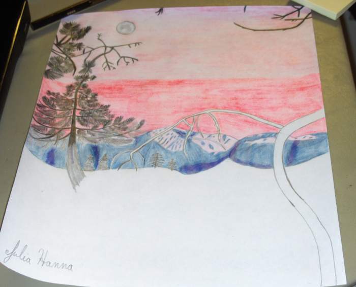 Here I am beginning to fill in the silhouette of the pine trees and the mountains with a black colored pencil.