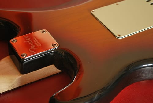 Back of a 2008 Fender Stratocaster Kenny Wayne Shepherd Signature, showing the holding plate and four screws of the Strat's bolt-on neck (as the well as the backplate that protects the guitar's bridge)