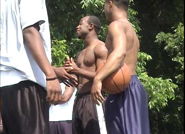 An argument, about the next play on the basketball court, is agreed to be settled with a "flip."