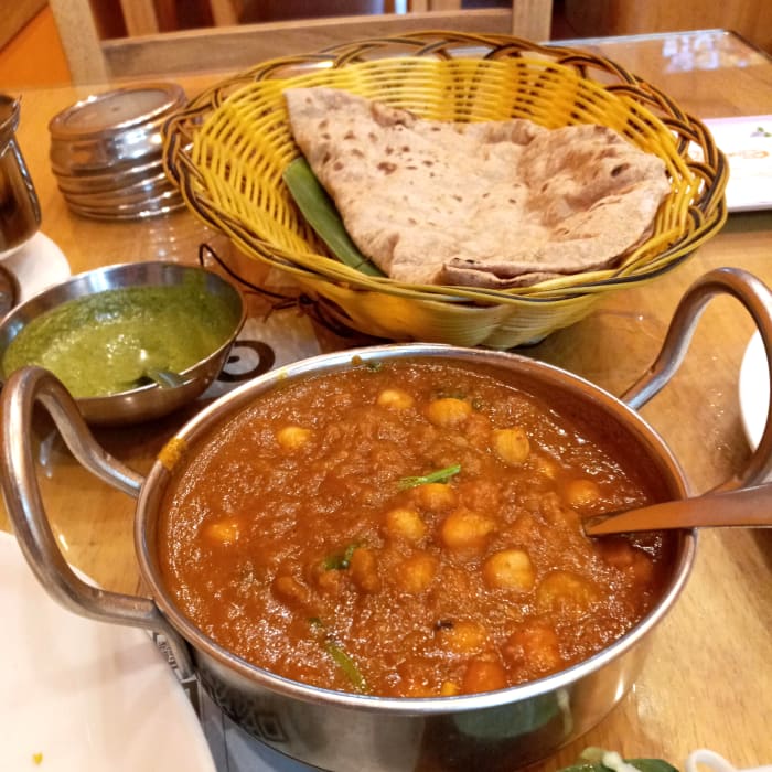 Indian restaurants will often remove the cream, ghee, or other non-vegan ingredients from curries on request.